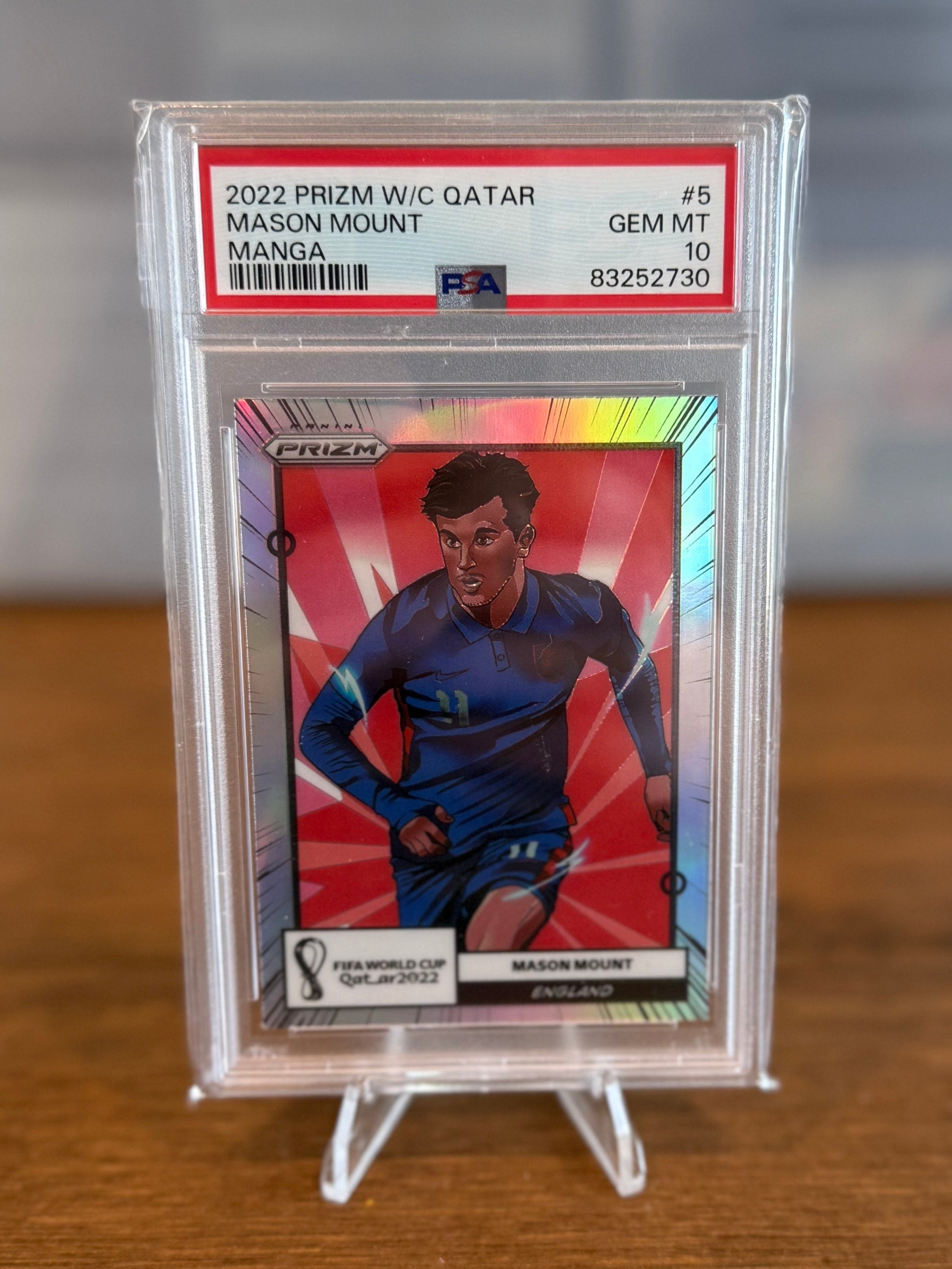 Trading card in a protective case on a wooden surface