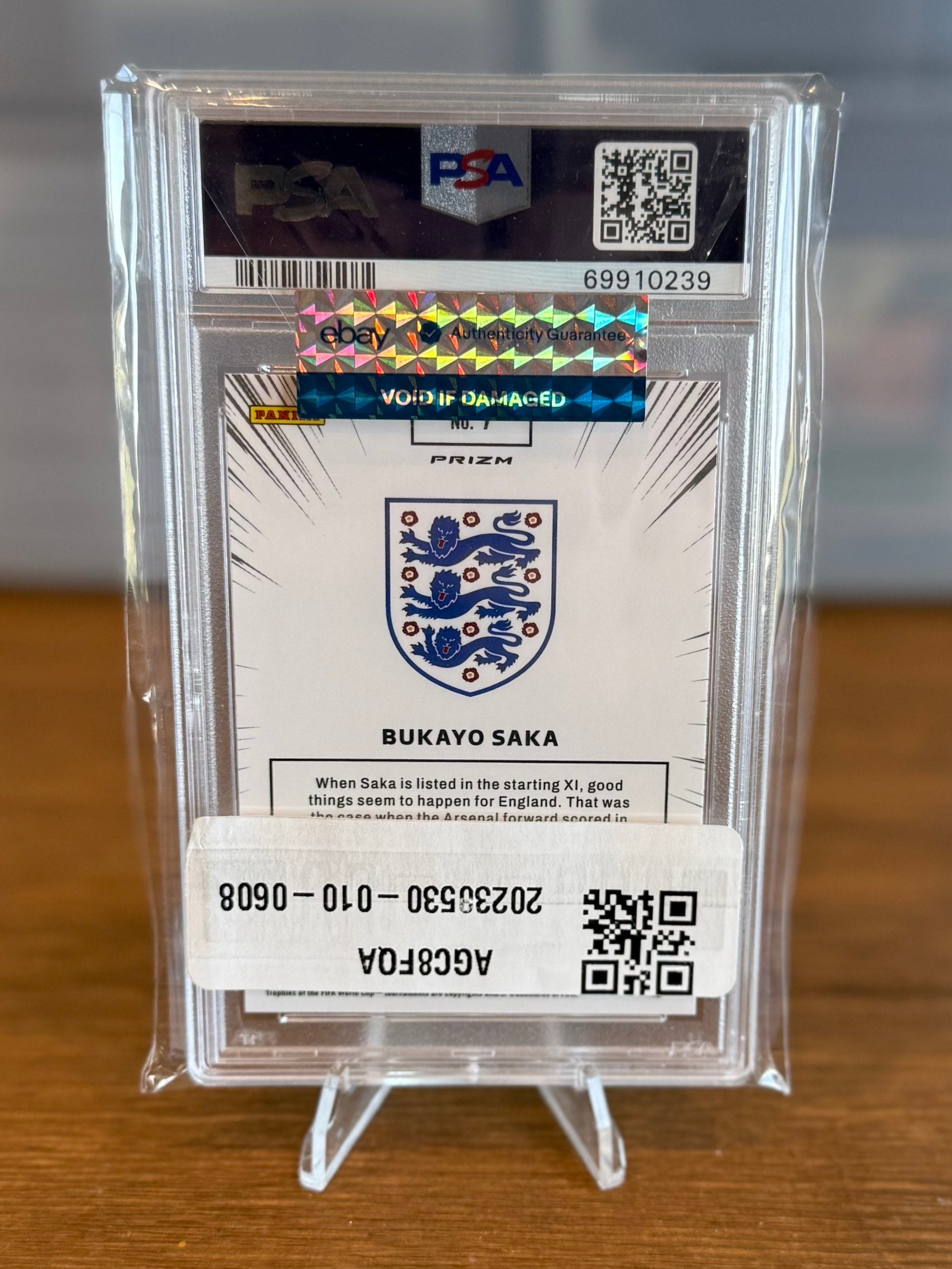 Trading card in a protective case on a wooden surface